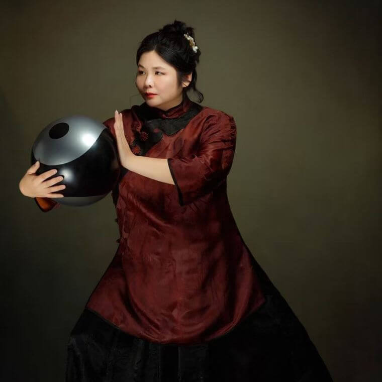 Chendan Cui-Laughton performs the "Hold the Moon in Your Arms" pose with a tai chi ball, a routine created by Master Gang Huang, founder of the Gou Xuan Tai Chi Academy. Trained in the Chen style at the Dongwu Tai Chi Research Institute, she has been perfecting this technique for three years during her stays in China.